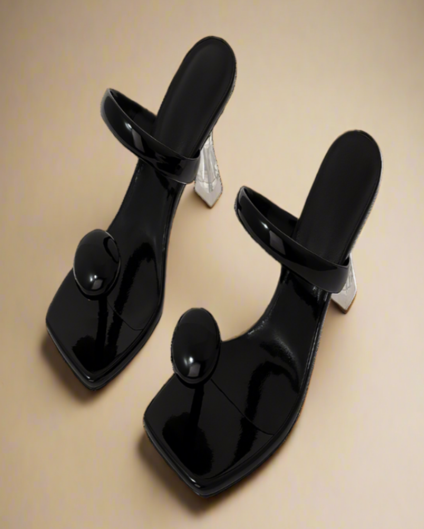 Pair of black high-heeled shoes on a white background